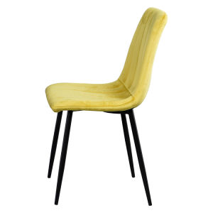 A modern dining room with a white table, four Indoor Velvet Dining Chairs with velvet fabric, and a gray rug, against a blue and white wall with minimalistic artwork.