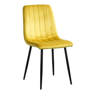 A modern dining room with a white table, four Indoor Velvet Dining Chairs with velvet fabric, and a gray rug, against a blue and white wall with minimalistic artwork.