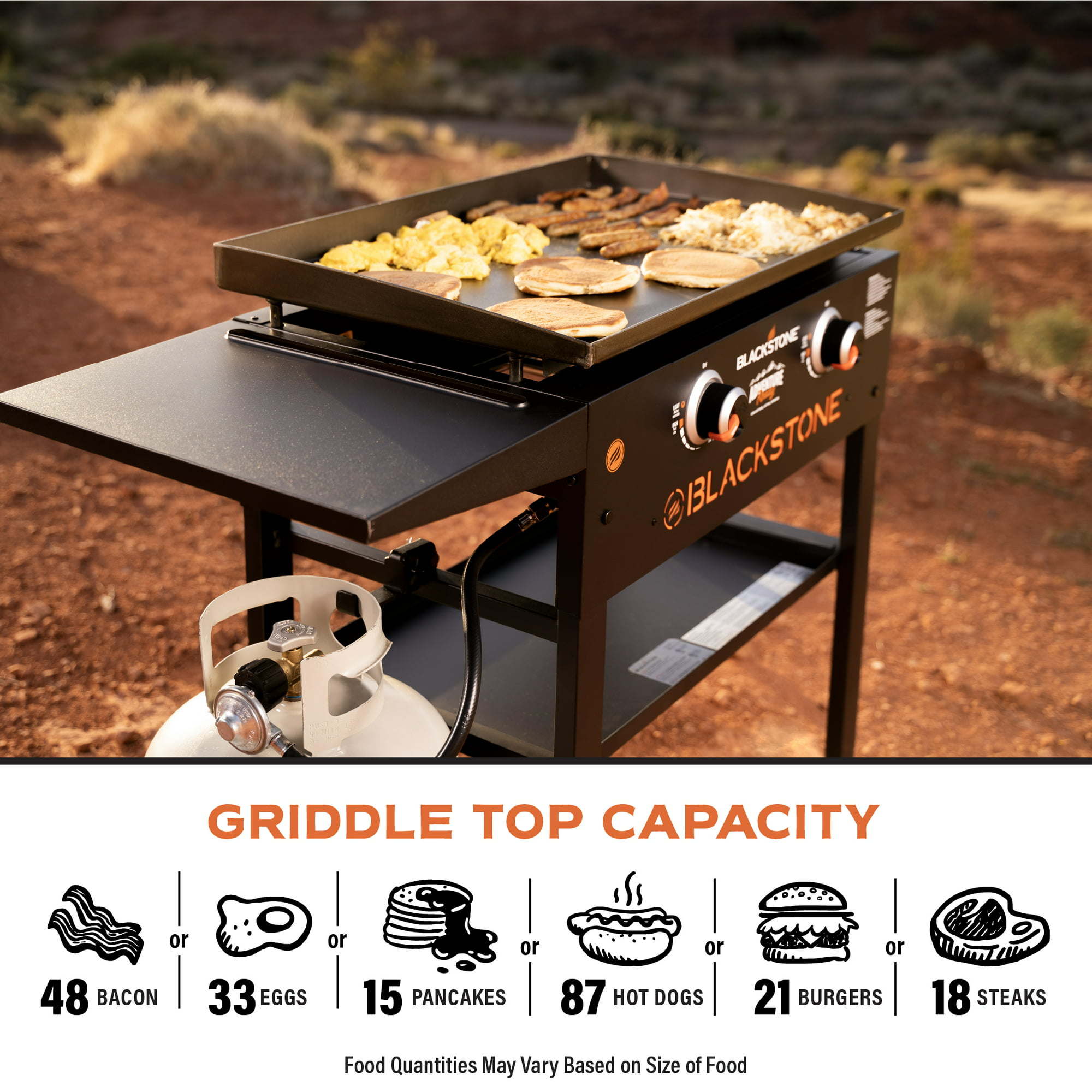 Close-up of an Adventure Ready 2-Burner 28" Griddle Cooking Station connected to a propane tank with a side shelf, illuminated by warm sunlight.