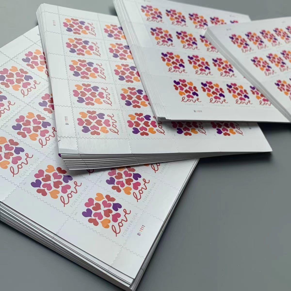 Five sheets of Hearts Blossom Love 2019 - 5 Sheets / 100 Pcs postage stamps; each sheet features multiple "Hearts Blossom Love" stamps with heart designs, arranged on a table.