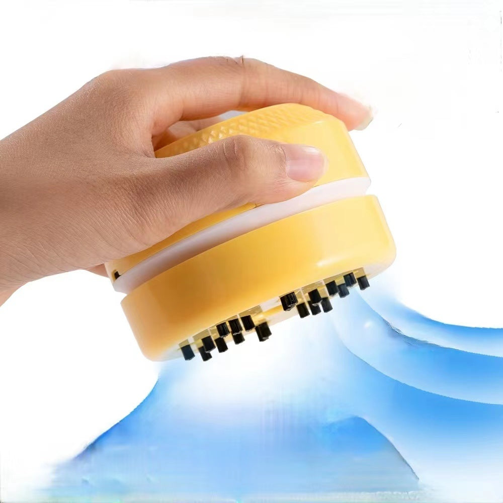 A hand clutching a Desktop Vacuum Cleaner, set against a backdrop that evokes flowing water.