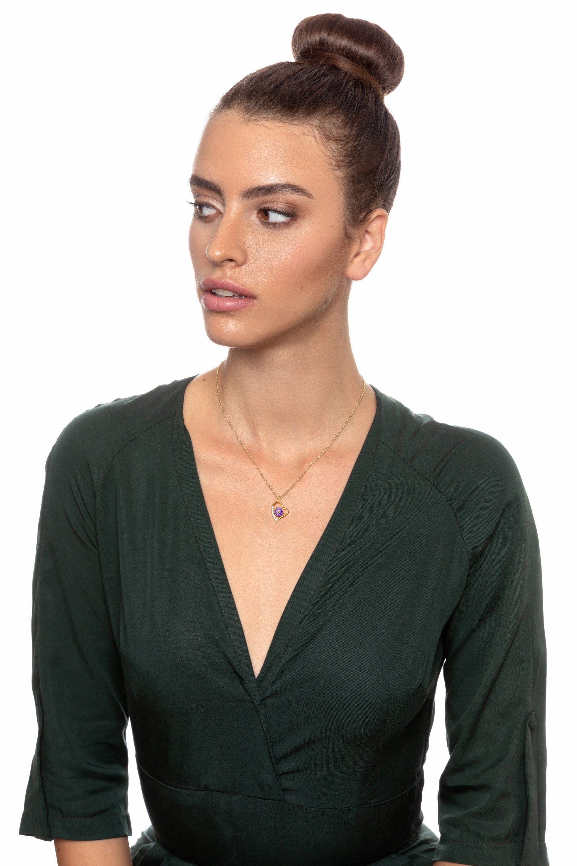 A decorative Gold Plated Silver Zodiac Heart Pendant Aquarius Necklace with a golden depiction of the water bearer, centered on a purple, Swarovski crystal background, encased in a gold frame.