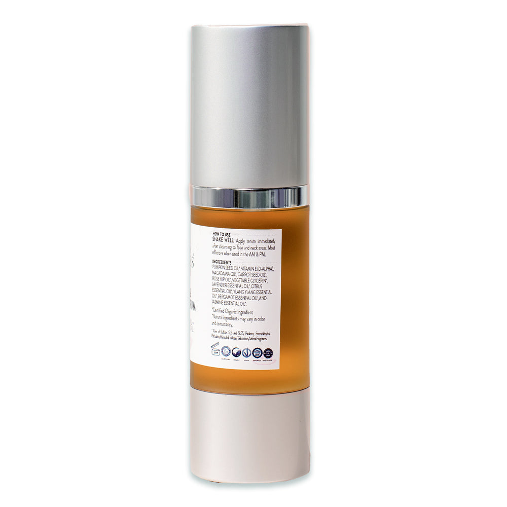 A bottle of Organic Pumpkin + Vitamin E Serum - Instant Glow Treatment with rosehip seed oil, packaged in a sleek silver dispenser.