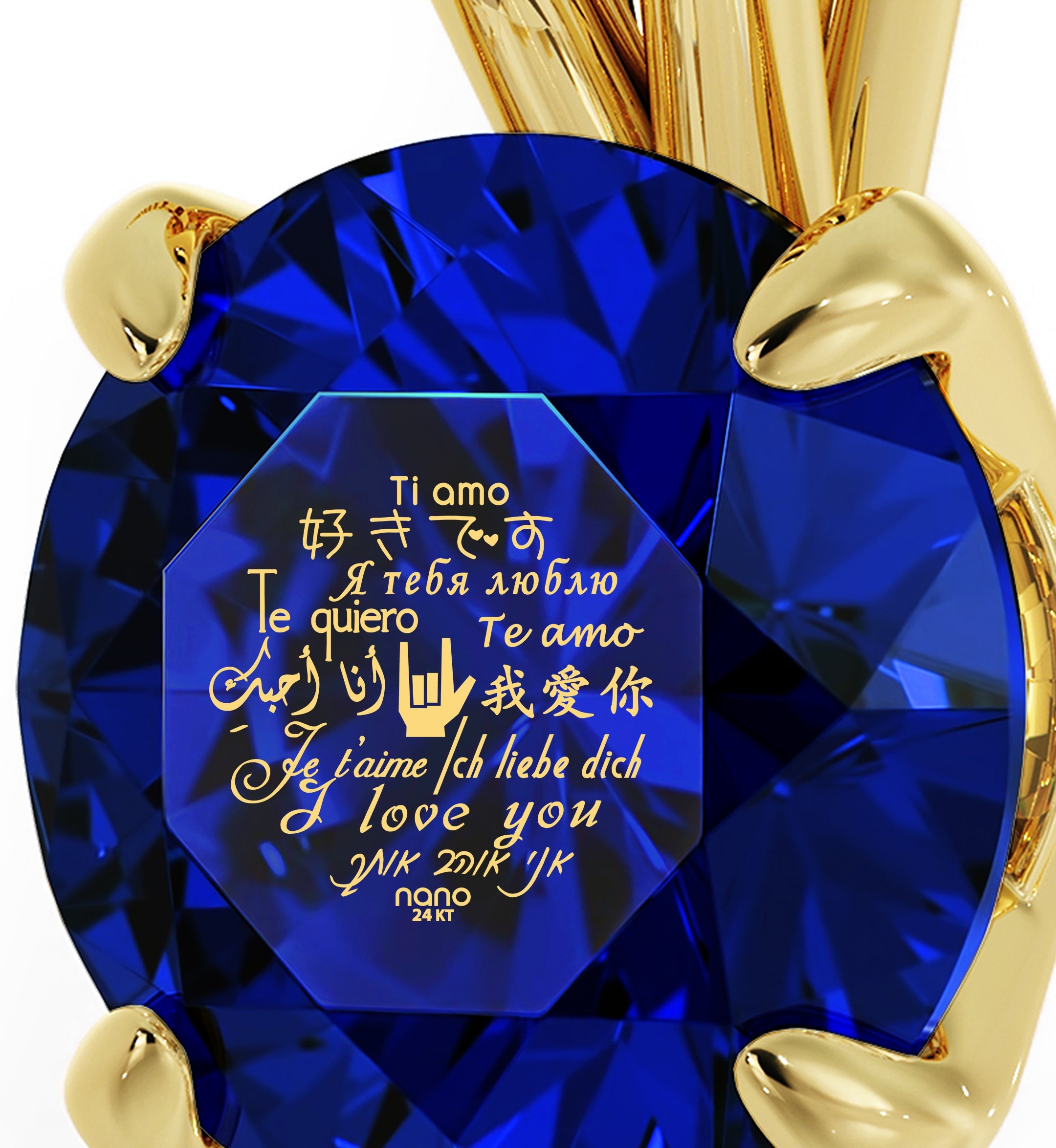 A close-up of a large Swarovski crystal held by a gold prong setting, with Gold Plated Silver I Love You Necklace Solitaire Pendant 12 Languages 24k Gold Inscribed written in multiple languages overlaying the gem.
