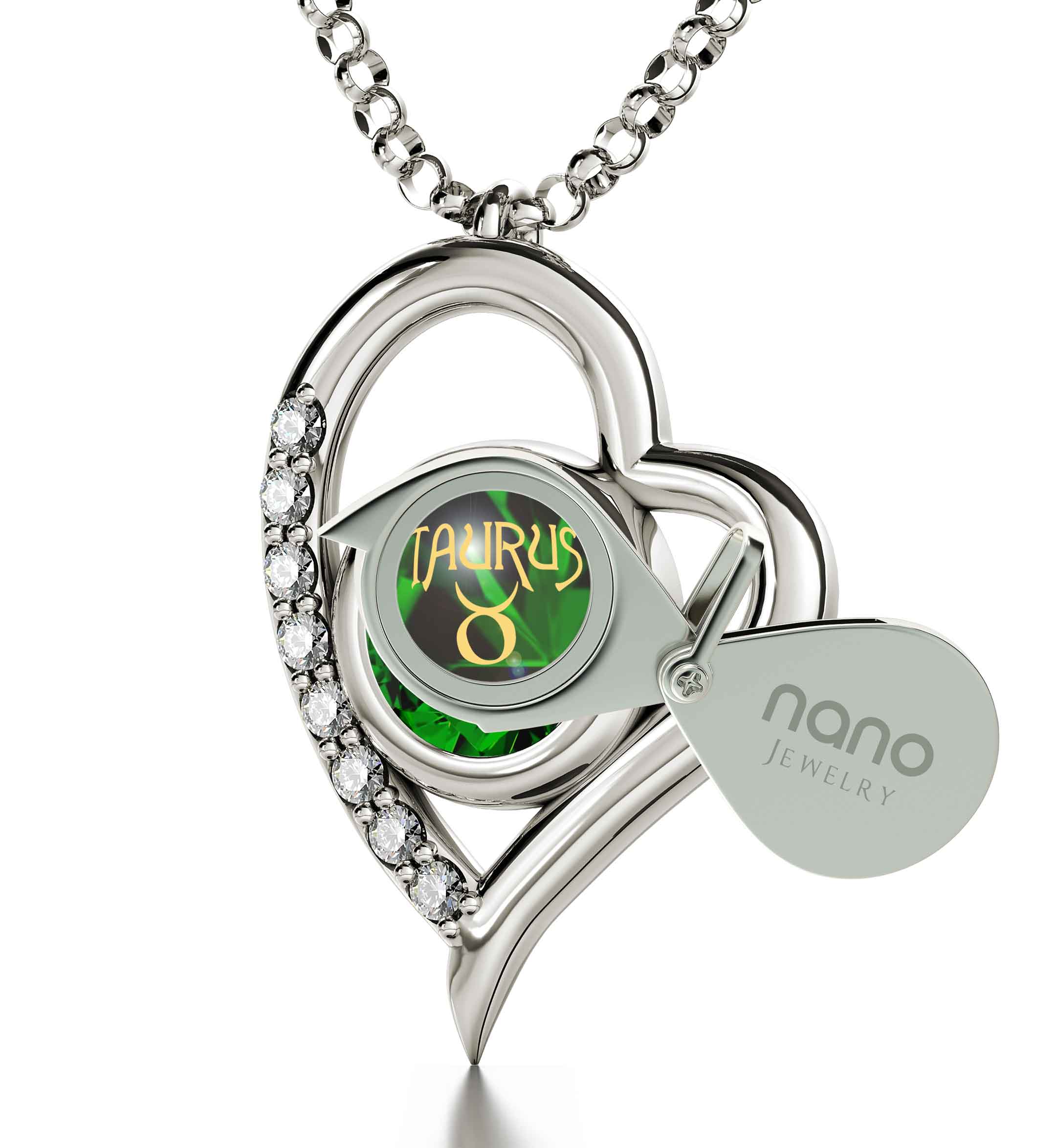 Close-up of a 925 Sterling Silver Taurus Necklace Zodiac Heart Pendant 24k Gold Inscribed on Crystal depicted in gold on a green geometric background, set in a silver ring encrusted with diamonds and featuring Taurus zodiac jewelry elements.