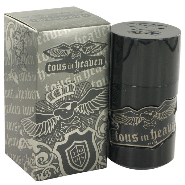 A black bottle of Tous In Heaven Eau De Toilette Spray 1.7 Oz For Men with an eagle on it next to a box.