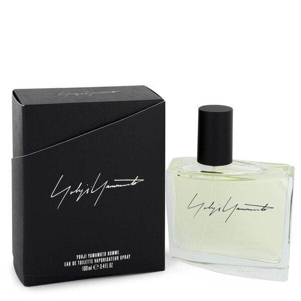 A bottle of Yohji Yamamoto Homme Eau De Toilette Spray 3.4 Oz For Men with a box next to it.
