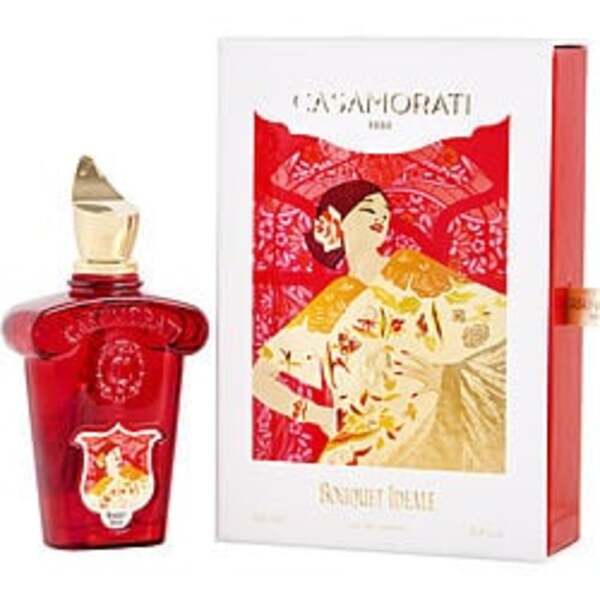 A red box with an image of a woman in a red dress, holding a bottle of Xerjoff Casamorati 1888 Bouquet Ideale By Xerjoff Eau De Parfum Spray 3.4 Oz (new Packaging) For Women.