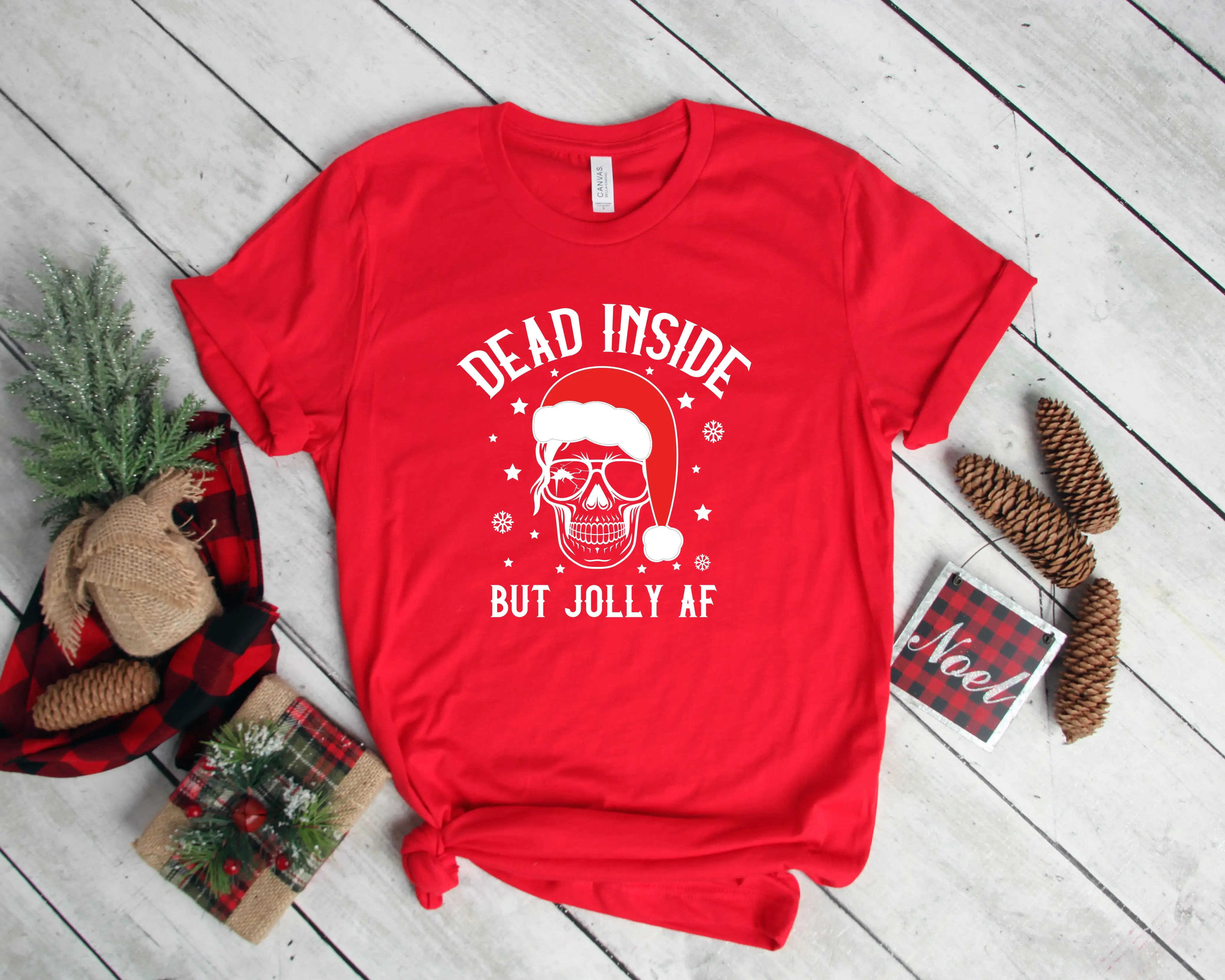 A festive Dead Inside But Jolly AF Christmas Skeleton Shirt with holiday decorations and casual attire, available in unisex sizes.