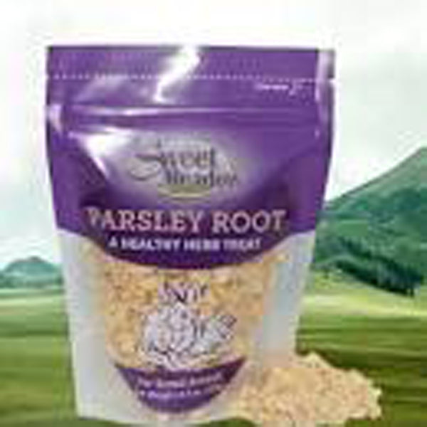 A bag of Sweet Meadow Farm Parsley Root Healthy Herb Small Animal Treat 1ea/1.3 oz in front of a grassy field.