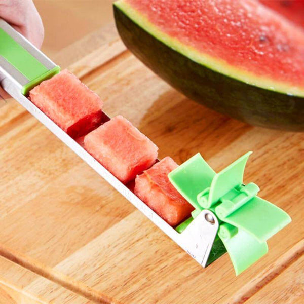 A person cutting a Windmill Watermelon Slicer.