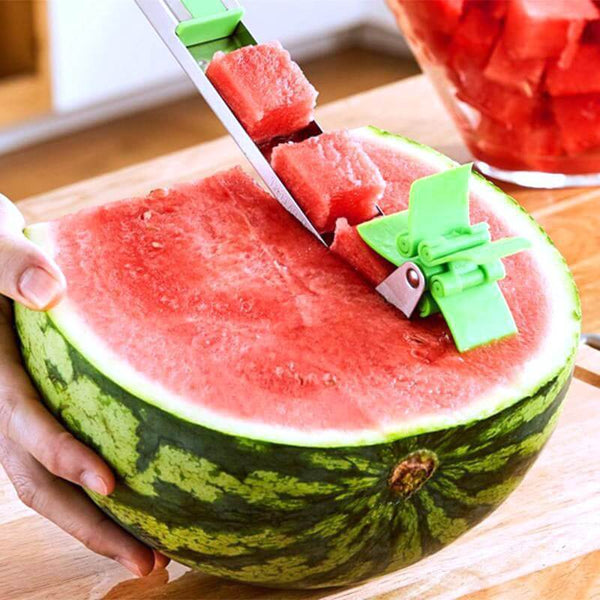 A person cutting a Windmill Watermelon Slicer.