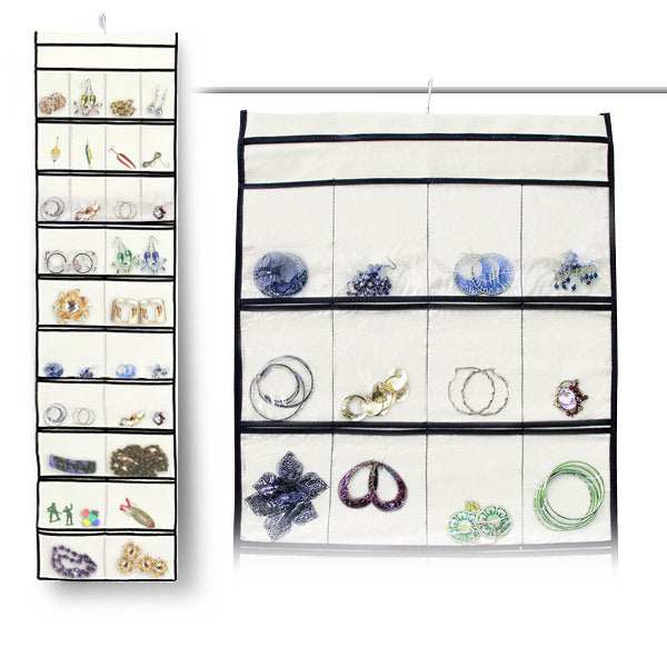 A Stylishly Stored 52 Pocket Hanging Canvas Jewelry Organizer with a lot of jewelry on it.