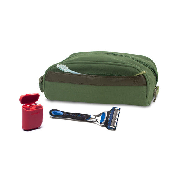 A green Travelon Classic Plus Top Zip Toiletry Kit Travel Accessory Bag Olive bag with a razor and shaver.
